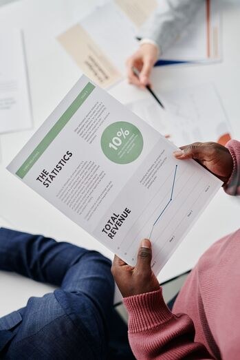 Two people reviewing a printed report